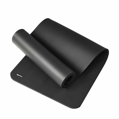 Black rolled yoga mat on a white background